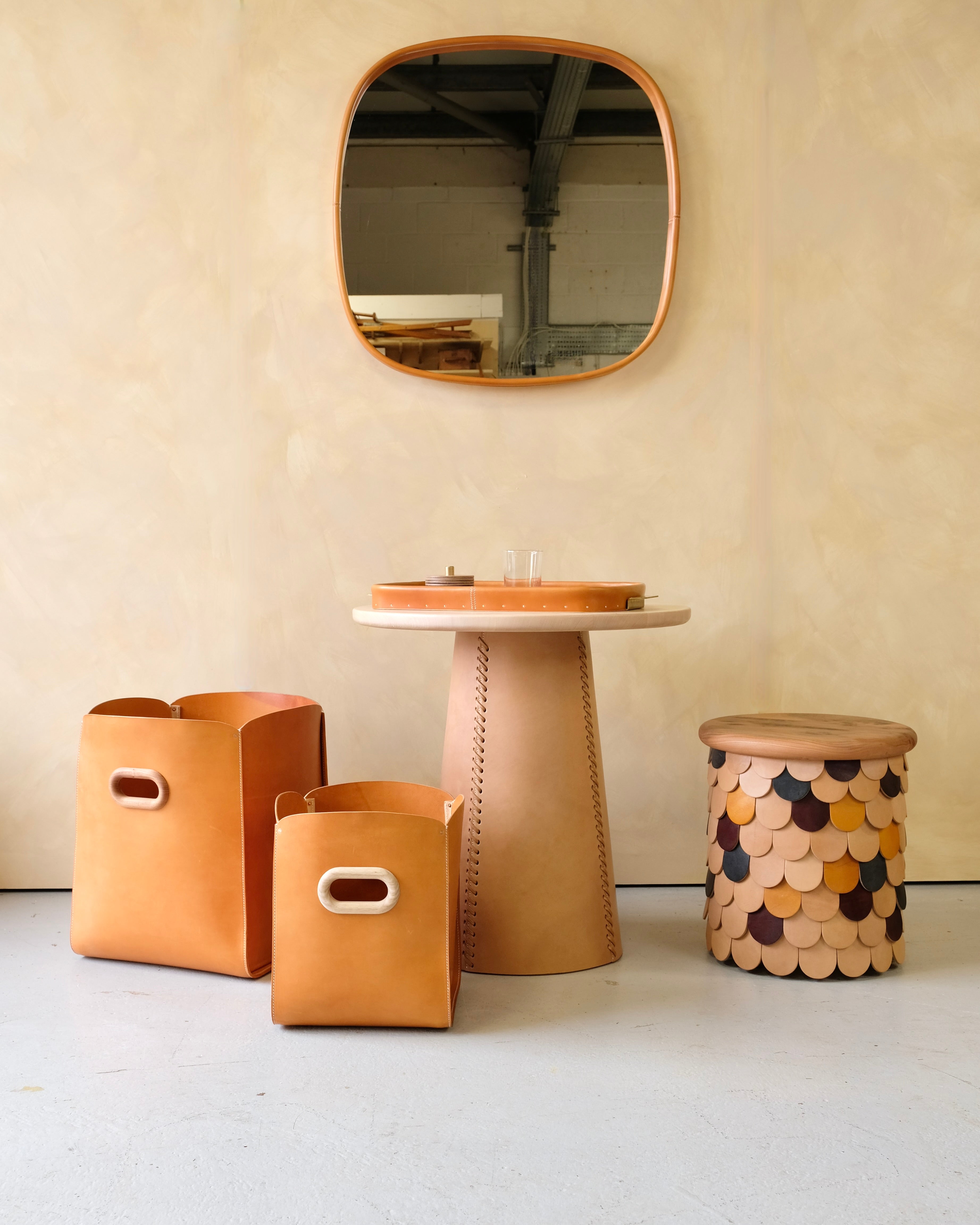 Premium handmade leather bound mirrors in geometric shapes in eight hand-dyed colours.