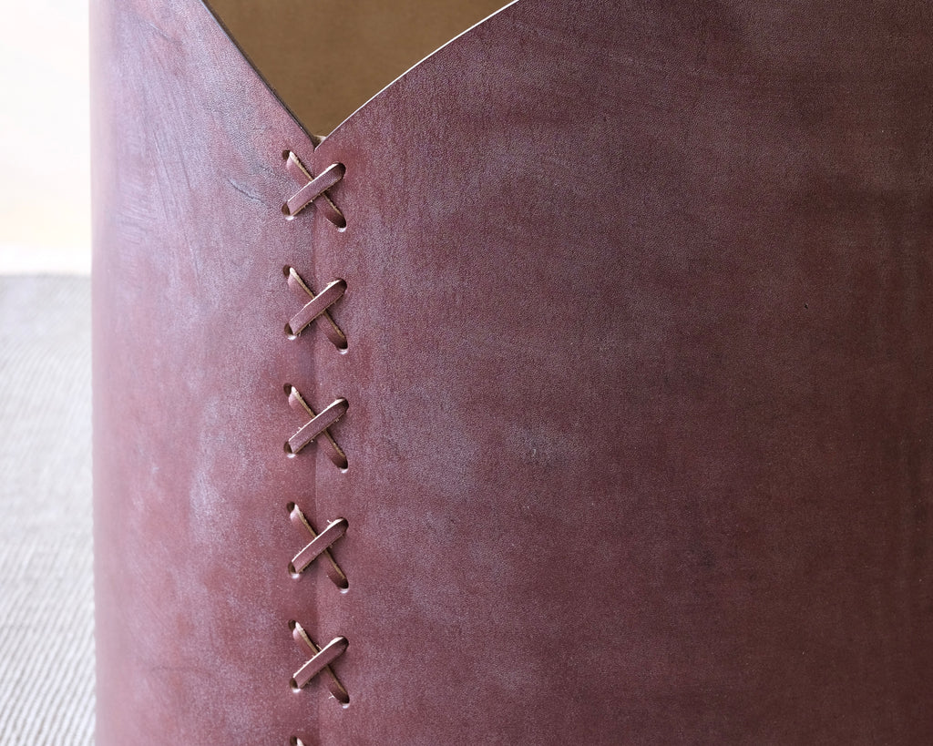 Close-up of a burgundy leather log basket