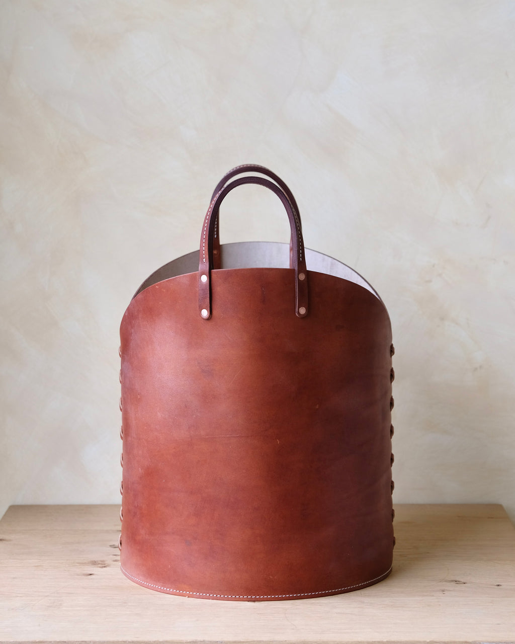 Face of dark brown handmade leather log basket