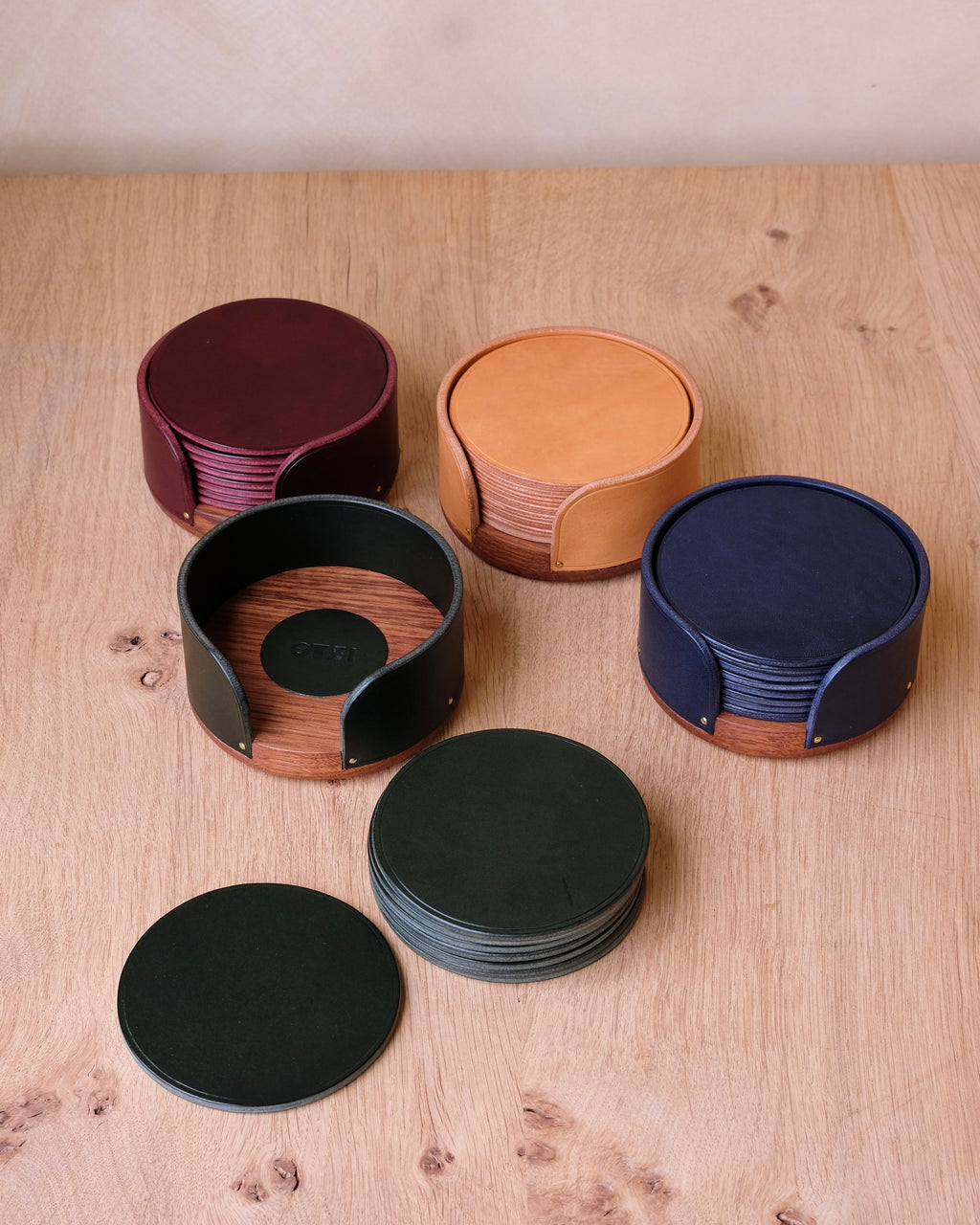 Set of round coasters in various colors on a wooden surface