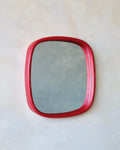 Rectangular mirror with a red leather frame on a white background